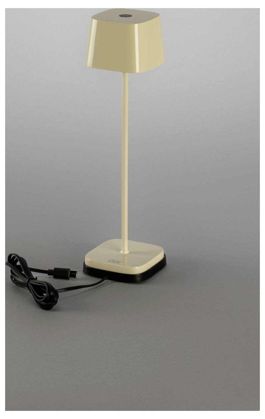 Goldene kabellose LED-Tischlampe mit rechteckiger Basis und Ladekabel auf grauem Hintergrund.