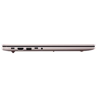 Seitenansicht eines geschlossenen rosé-goldenen Laptops mit dünnem Profil und Anschlüssen an der Unterkante.