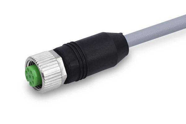 Nahaufnahme eines schwarzen und silbernen kreisförmigen elektrischen Steckverbinders mit einem grünen Einsatz auf einem grauen Kabel, isoliert auf weißem Hintergrund.