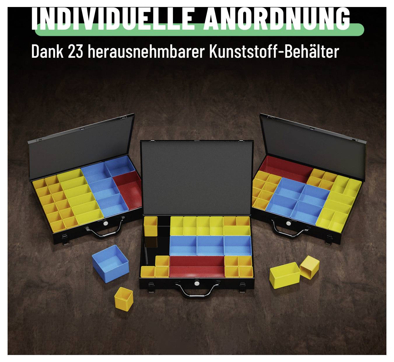 Schwarzer Koffer mit 23 herausnehmbaren Kunststoffbehältern; gelbe, blaue und rote Behälter sind angeordnet, mit deutschem Text „INDIVIDUELLE ANORDNUNG" und „Dank 23 herausnehmbarer Kunststoff-Behälter".