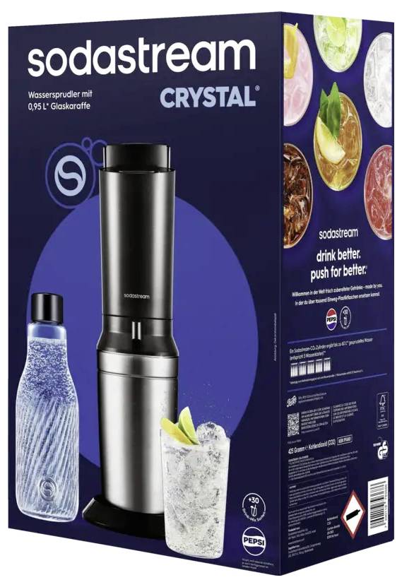 SodaStream Crystal Sprudelwasserhersteller-Karton mit schwarzsilberner Maschine, Glasflasche und Getränkefotos; Text liest „sodastream CRYSTAL" und „drink better. push for better." (Trinke besser. Drücke für Besser.)