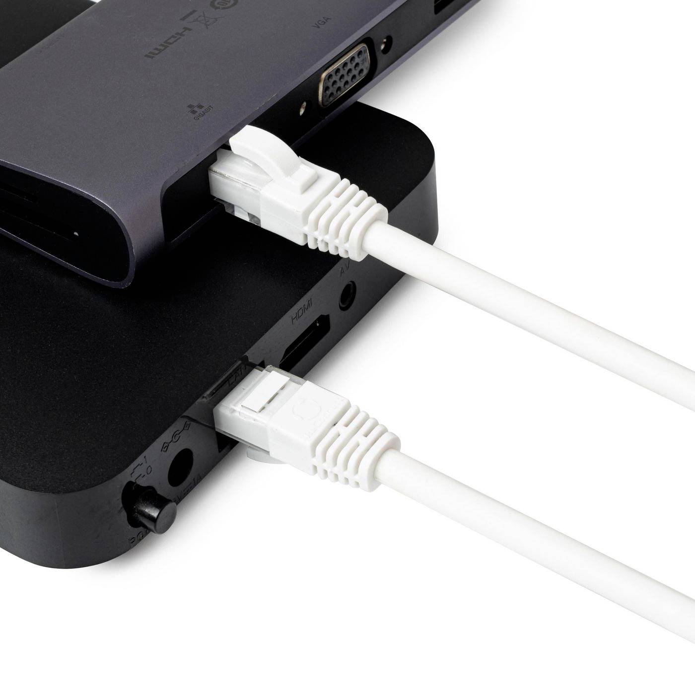 Nahaufnahme von zwei übereinander gestapelten schwarzen elektronischen Geräten, die durch weiße Kabel verbunden sind und Seitenports sowie Anschlüsse zeigen.