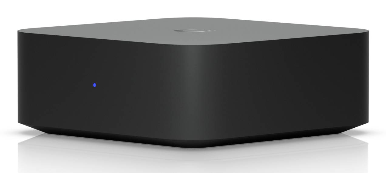 Schwarzer zylindrischer Lautsprecher oder Smart-Home-Gerät mit einem kleinen blauen Statuslicht an der Vorderseite, gezeigt vor weißem Hintergrund.