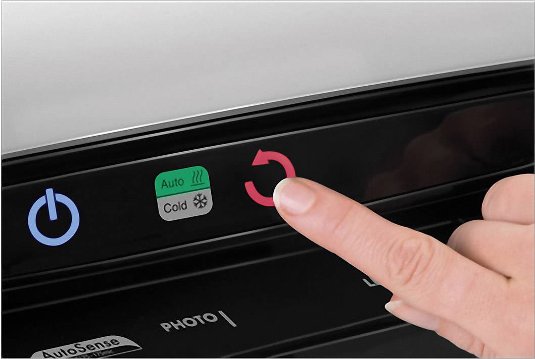 Eine Hand drückt eine Taste auf einem Geschirrspüler-Bedienfeld. Symbole zeigen Start, Auto-Modus, Kaltwascheinstellung und Reset.