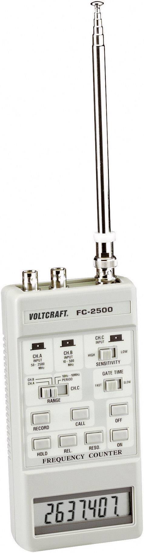 Handgerät mit Antenne und Bildschirm zeigt eine Frequenz von 2637407 an. Markenname 'Volcraft FC-250D'. Mehrere Tasten und Anschlüsse.