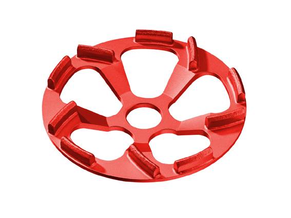 Ein rotes, scheibenförmiges Metallteil mit sechs abgerundeten Aussparungen um einen zentralen Kreis.