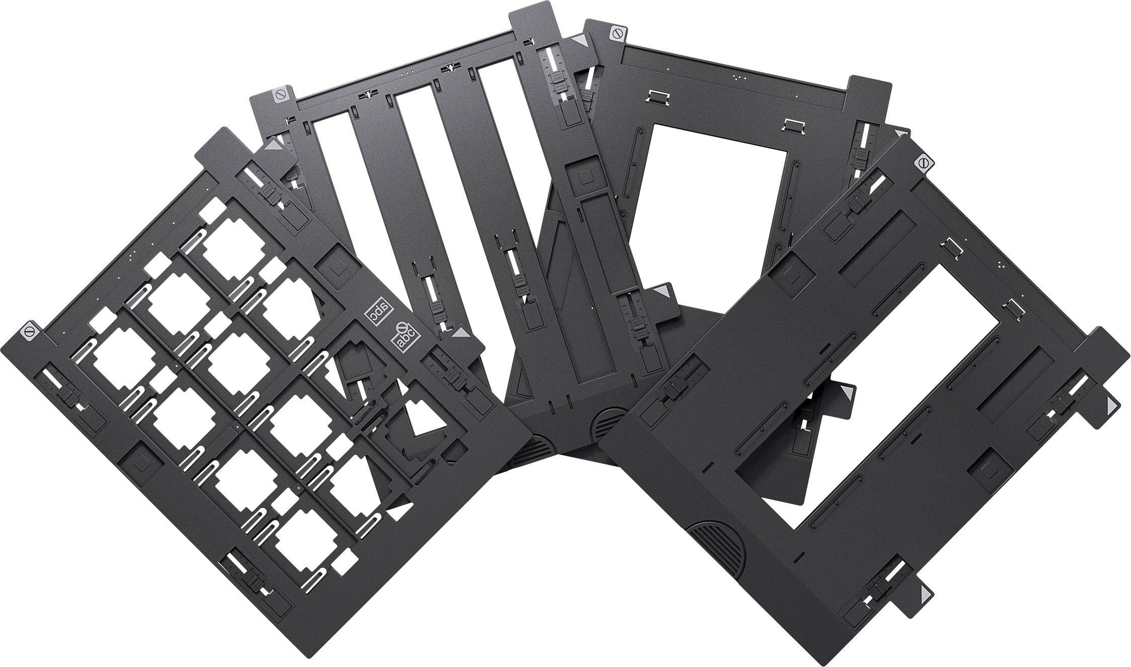 Eine Auswahl von schwarzen Dia- und Negativ-Scaneinsätzen, teilweise überlappend, auf weißem Hintergrund.