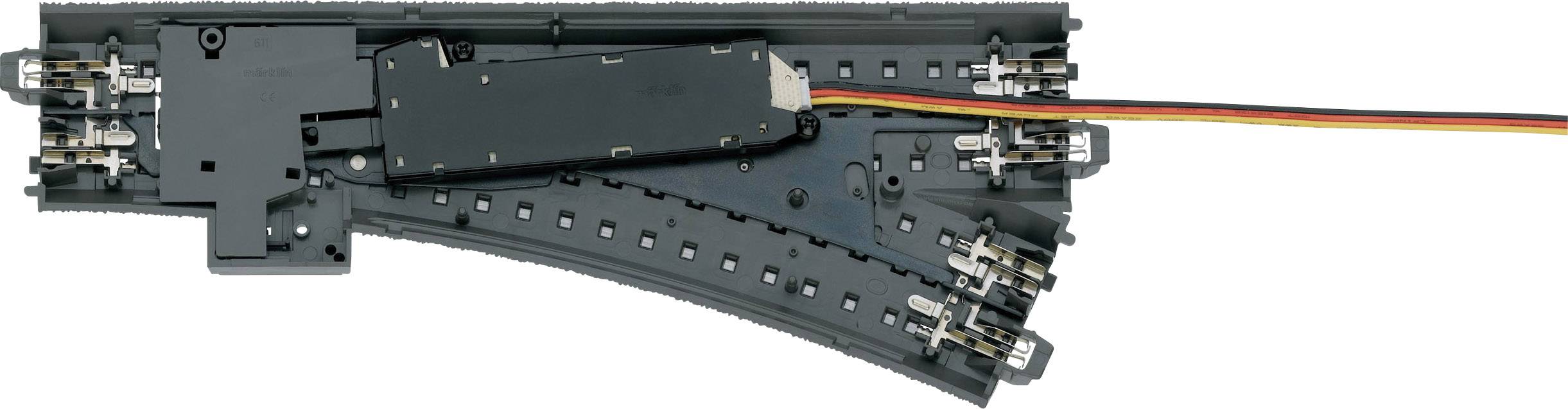 Modelleisenbahn-Weiche mit elektrischem Antrieb, zeigt Gleisverzweigung mit eingebautem Motor und mehrfarbigem Kabel zur Steuerung.