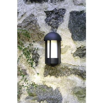 Außenwandleuchte aus schwarzem Metall, montiert an einer Steinmauer, spendet warmes Licht.