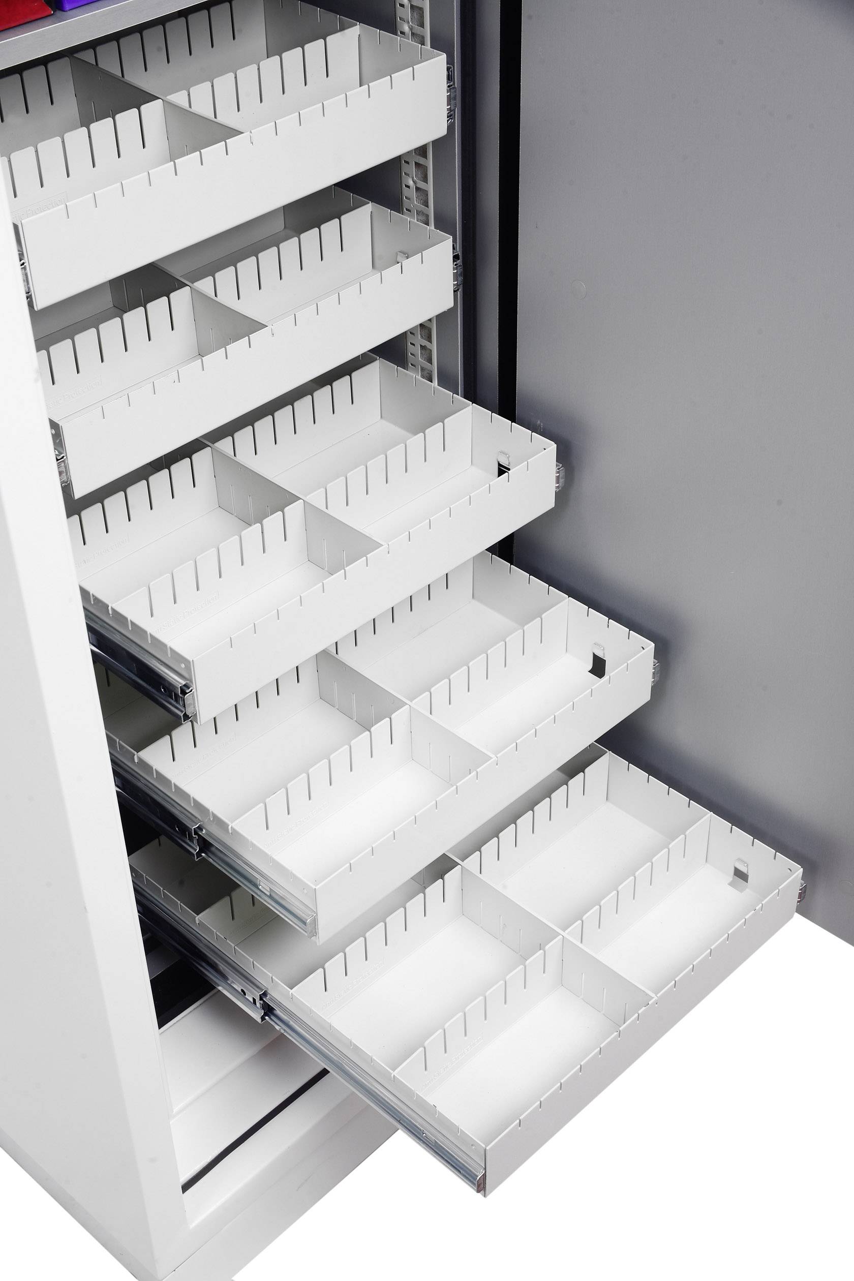 Ein Schrank mit mehreren geöffneten Schubladen, die in kleine rechteckige Fächer unterteilt sind, um eine organisierte Lagerung zu ermöglichen.