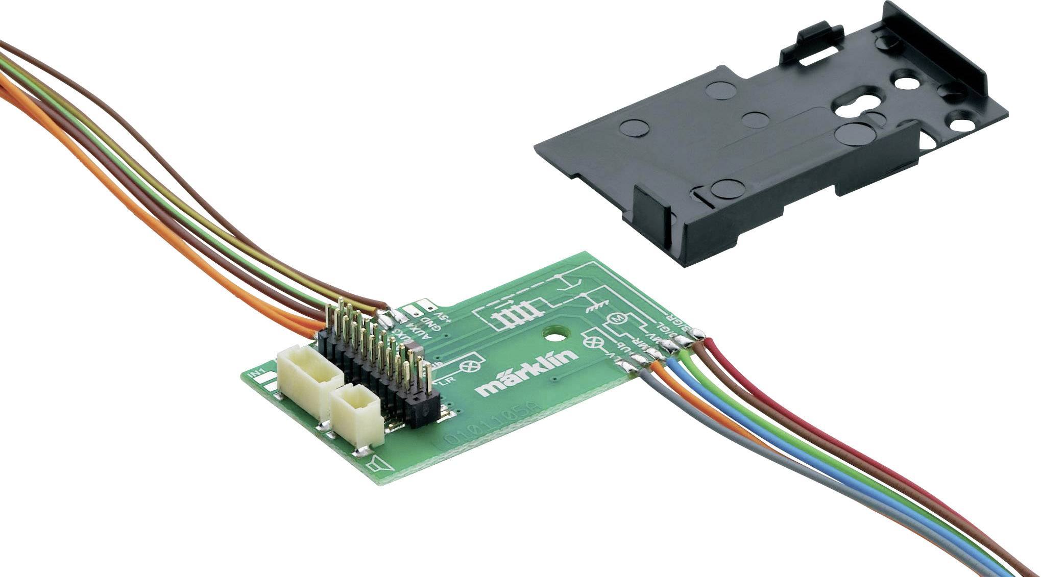 Eine grüne elektronische Platine mit mehreren bunten Kabeln und einem schwarzen Plastikgehäuse daneben.