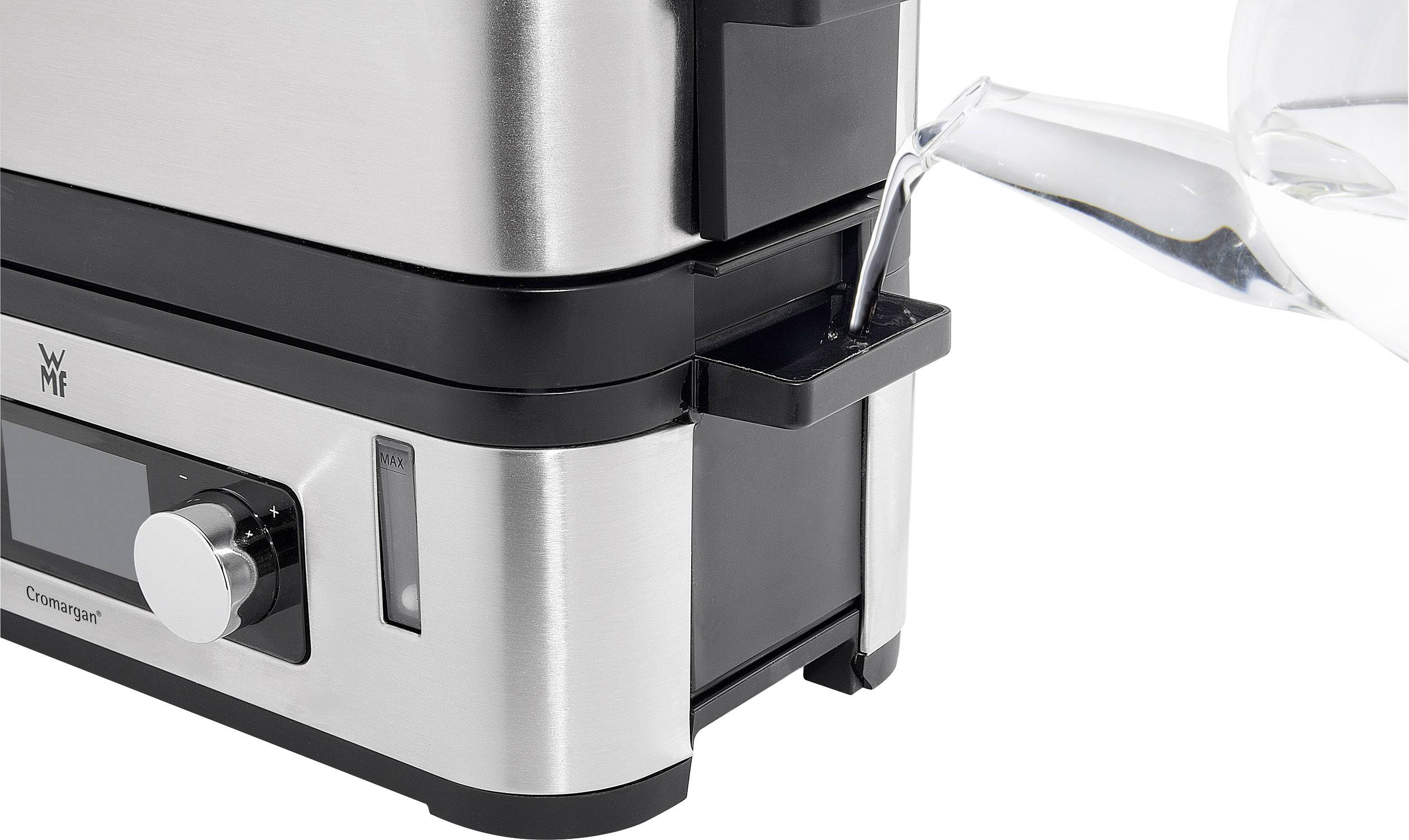 Ein Wasserkocher aus Edelstahl wird von der Seite mit Wasser befüllt.