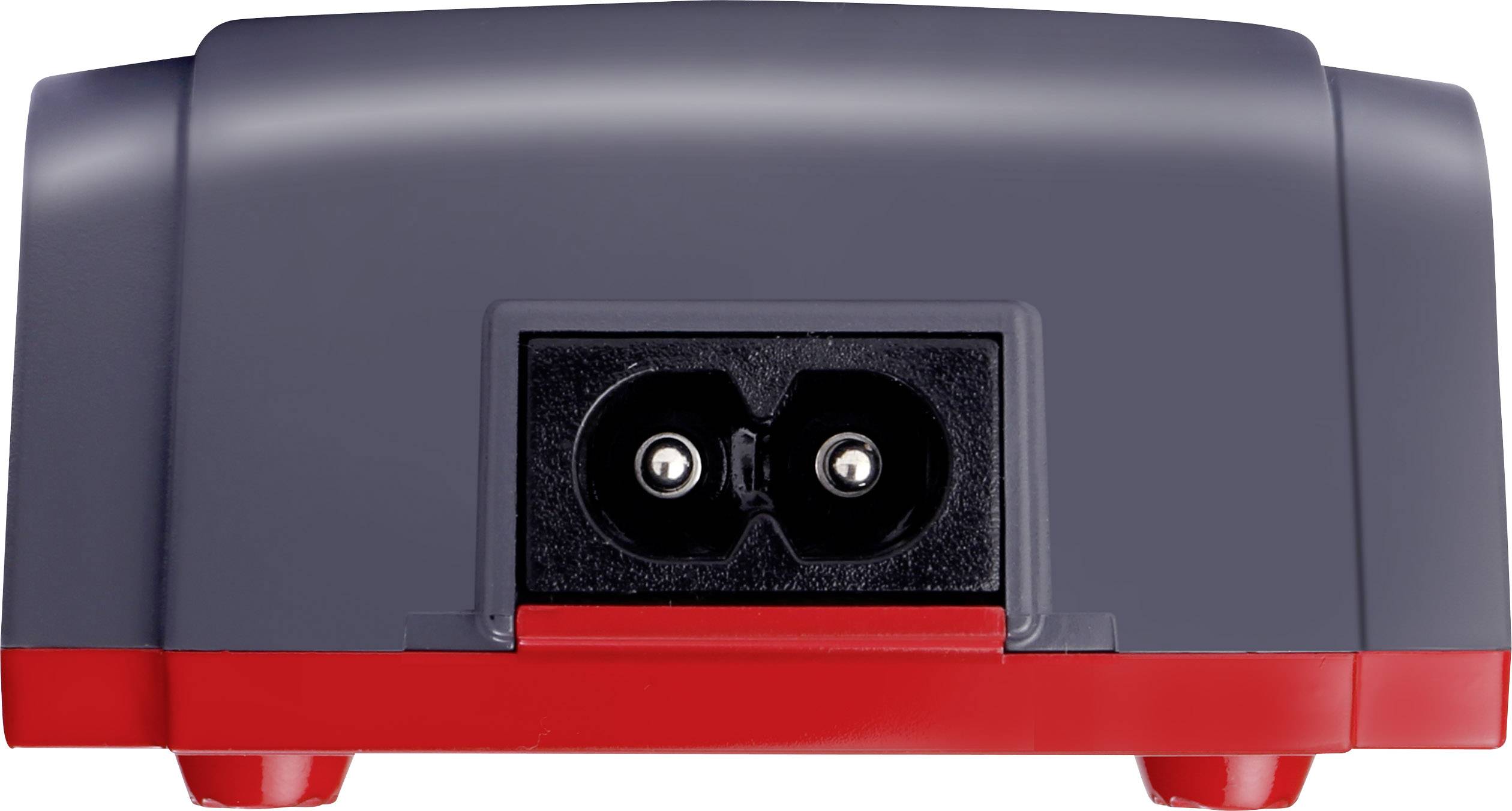 Ein graues und rotes elektrisches Gerät mit Anschlusspunkten auf der Rückseite; möglicherweise ein Ladegerät oder Netzteil.