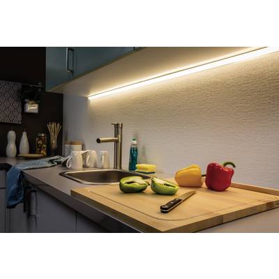 Gemütliche Küche mit Arbeitsplatte, Schneidebrett, Paprika, Messer und Spüle. Warmes Licht sorgt für eine einladende Atmosphäre.