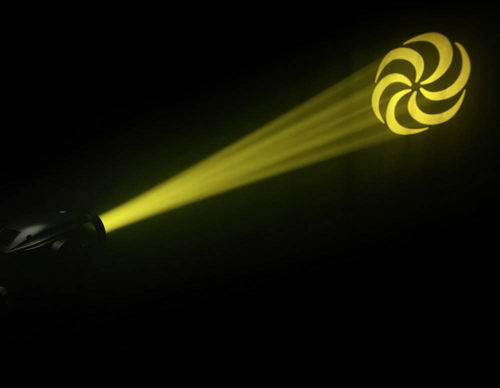 Ein gelbes Lichtstrahl trifft auf ein markantes spiralförmiges Muster, das aus Kreissegmenten besteht, in einem dunklen Raum.