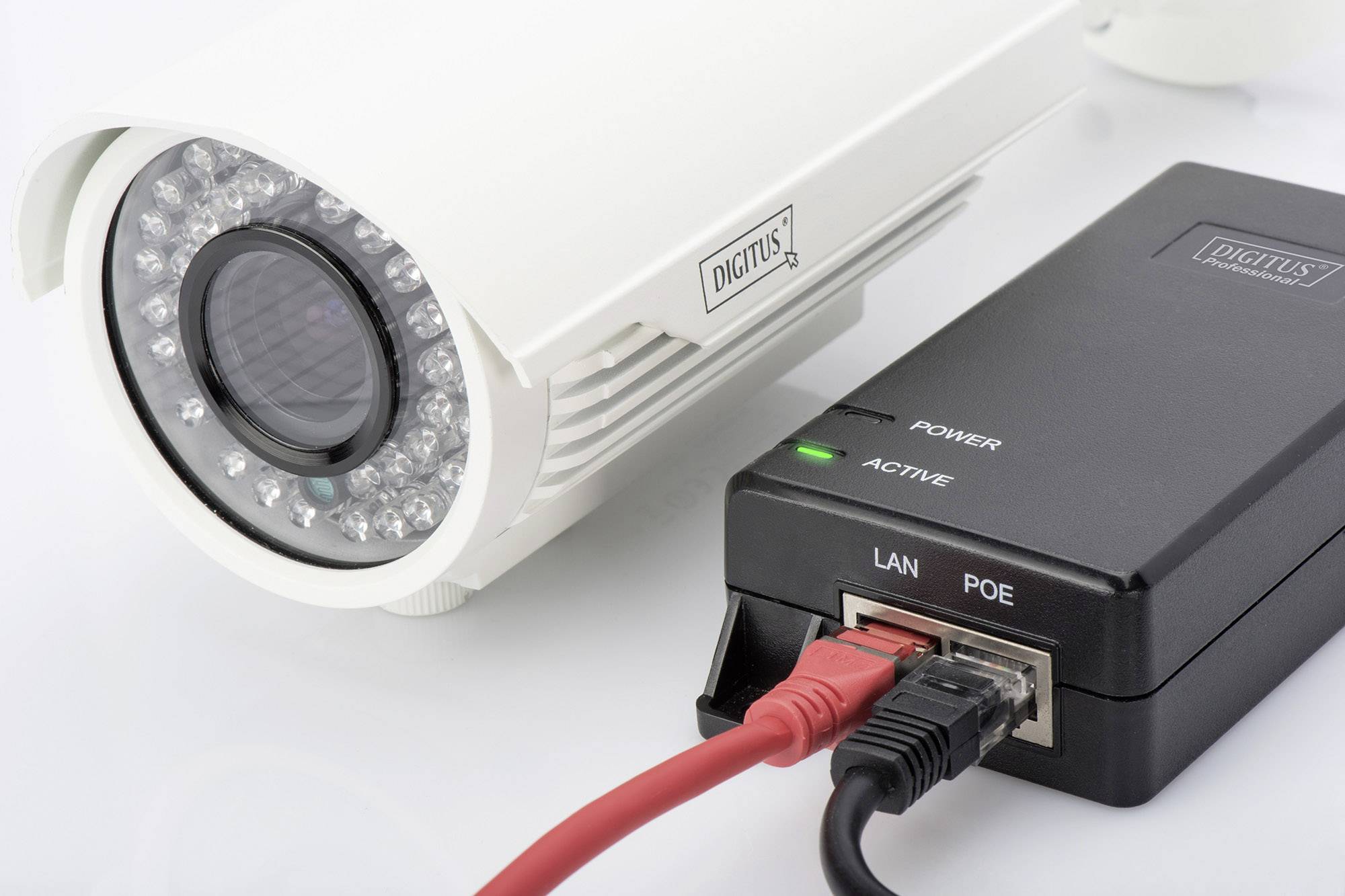 Eine Überwachungskamera mit Netzwerkkabeln ist mit einer Power-over-Ethernet-Box verbunden, die Strom- und Netzwerkverbindungen anzeigt.