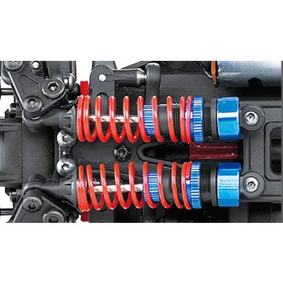 Nahaufnahme eines Federungssystems eines Fahrzeugs, das rote Spiralfedern und blaue Stoßdämpfer zeigt, montiert an einer schwarzen Metallstruktur.