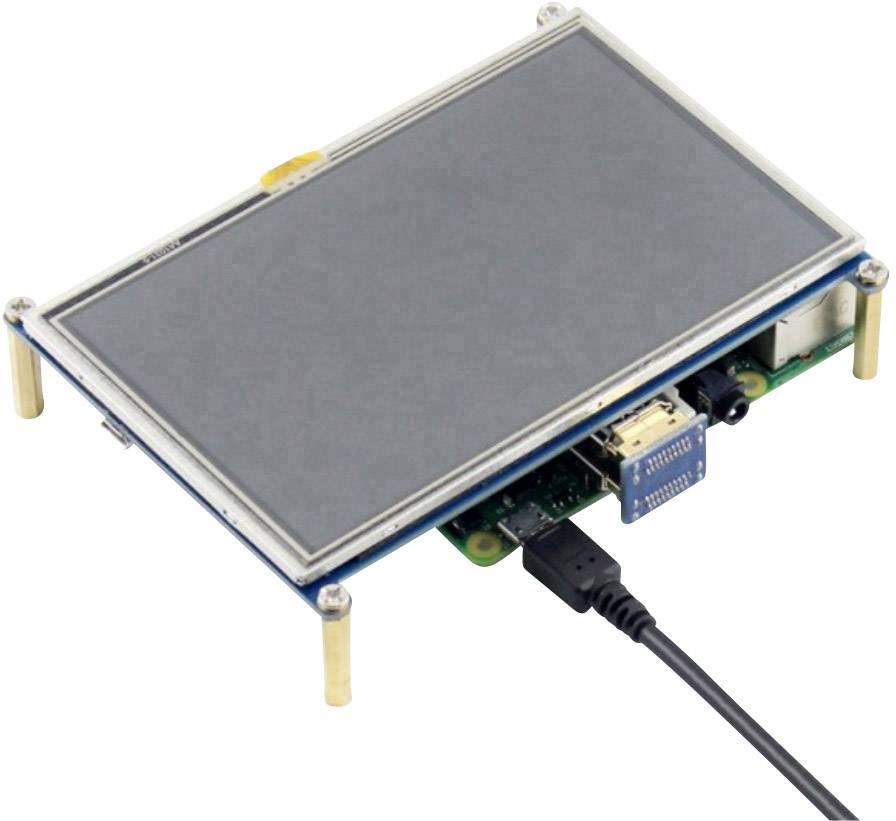 Ein kleiner Computer mit Touchscreen-Display, verbunden über USB-Kabel. Aufgestellt auf vier Standfüßen, bereit zur Nutzung.