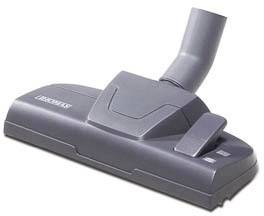 Graue Staubsaugerdüse auf weißem Hintergrund. Geeignet für Teppich- oder Hartbodenreinigung, rechteckige Form mit schwenkbarem Anschluss.