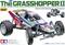 'The Grasshopper II' Verpackung zeigt ein ferngesteuertes Rennauto von Tamiya, rot-blau-weiß lackiert, mit der Nummer 56 auf der Seite.