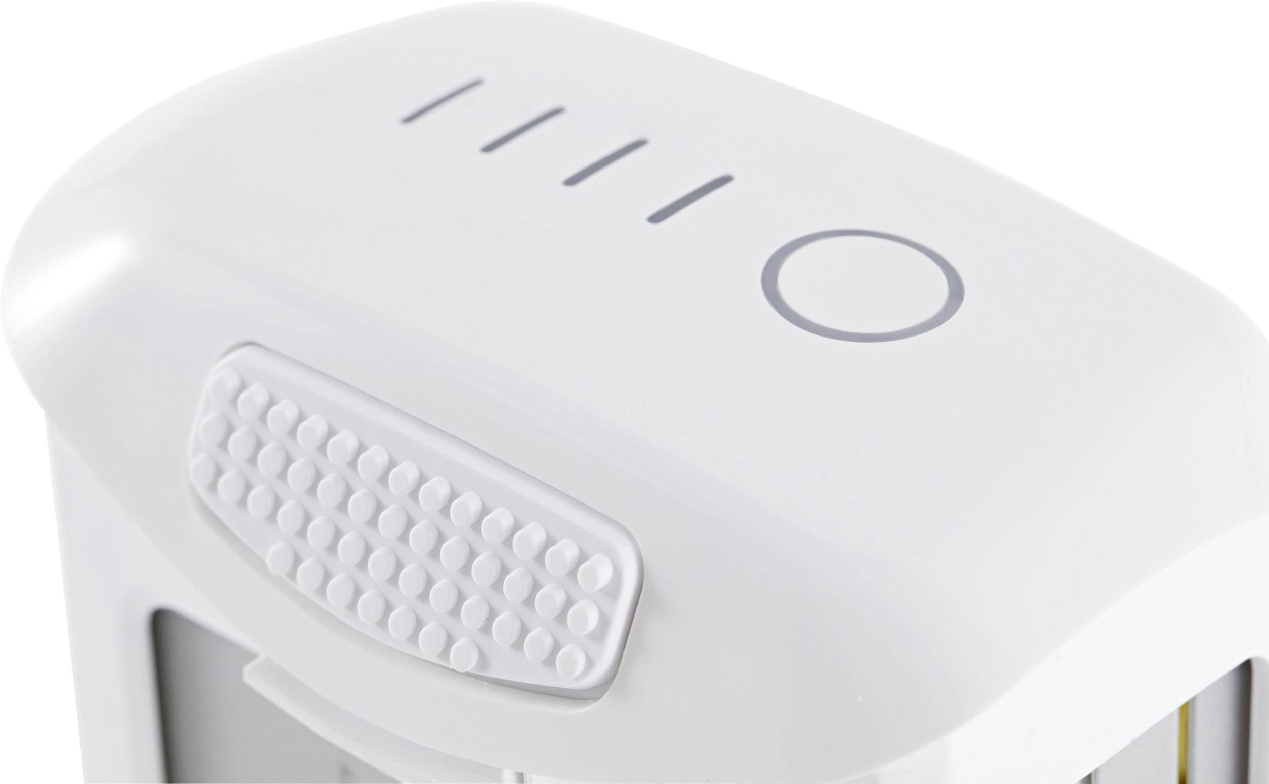 Ein weißes Gerät mit einem Kreis und drei Linien oben. Es scheint sich um ein elektronisches Gerät mit einer strukturierten Oberfläche zu handeln.