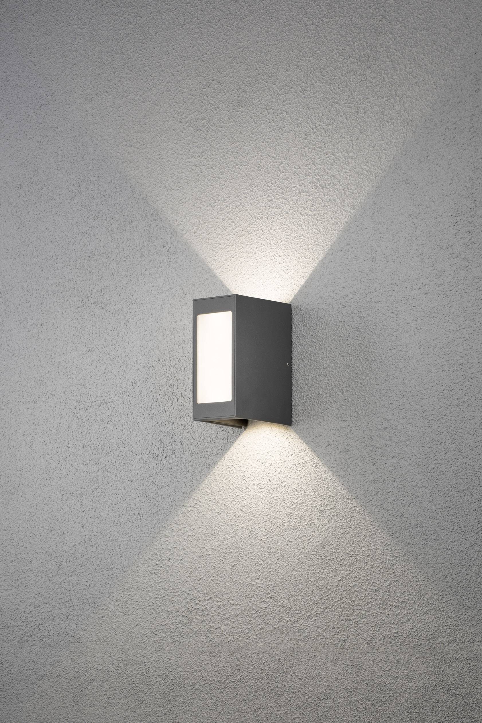 Moderne Wandleuchte mit rechteckigem Gehäuse in Grau. Leuchtet nach oben und unten, erzeugt ein dezentes Licht- und Schattenspiel.