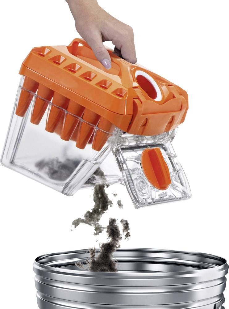 Eine Hand leert einen transparenten Staubbehälter mit orangefarbenem Deckel in einen Metall-Mülleimer. Staub und Schmutz fallen heraus.