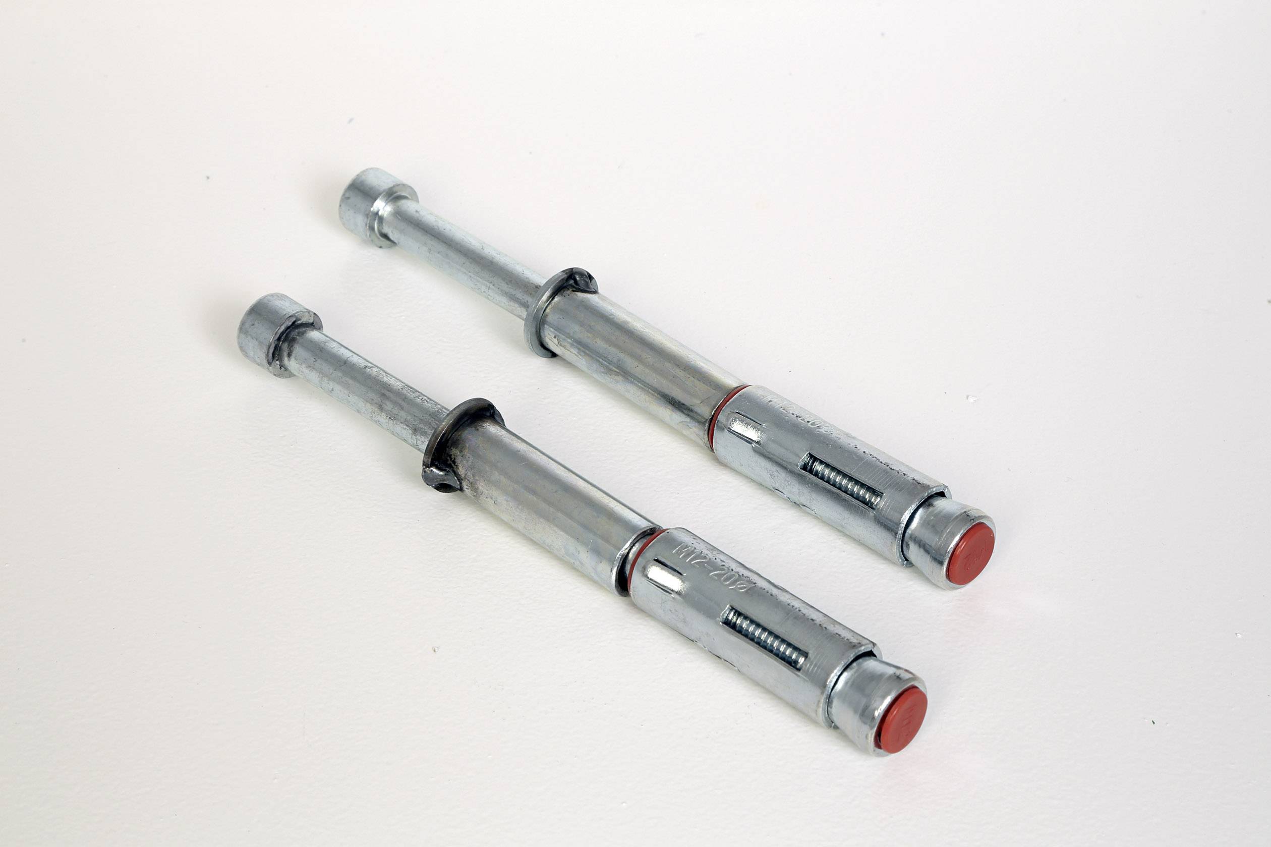 Zwei Metall-Ankerbolzen auf weißem Hintergrund, parallel zueinander ausgerichtet.