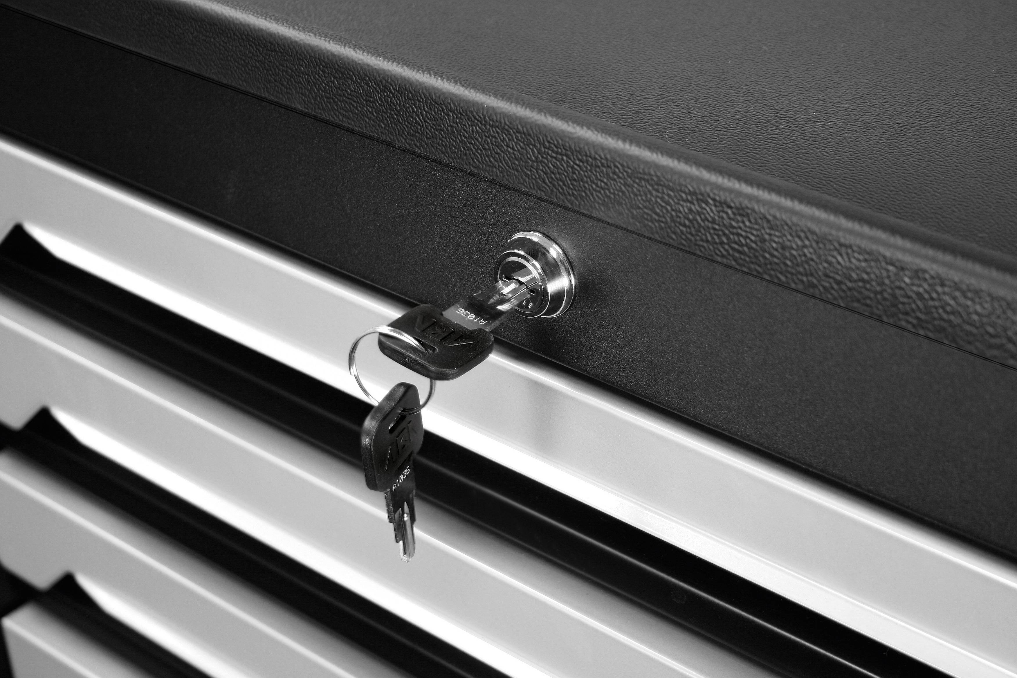 Fünfschubladenschrank mit schwarzer Oberfläche und einem Schlüssel im Schloss, der aus dem oberen Schubfach herausragt.