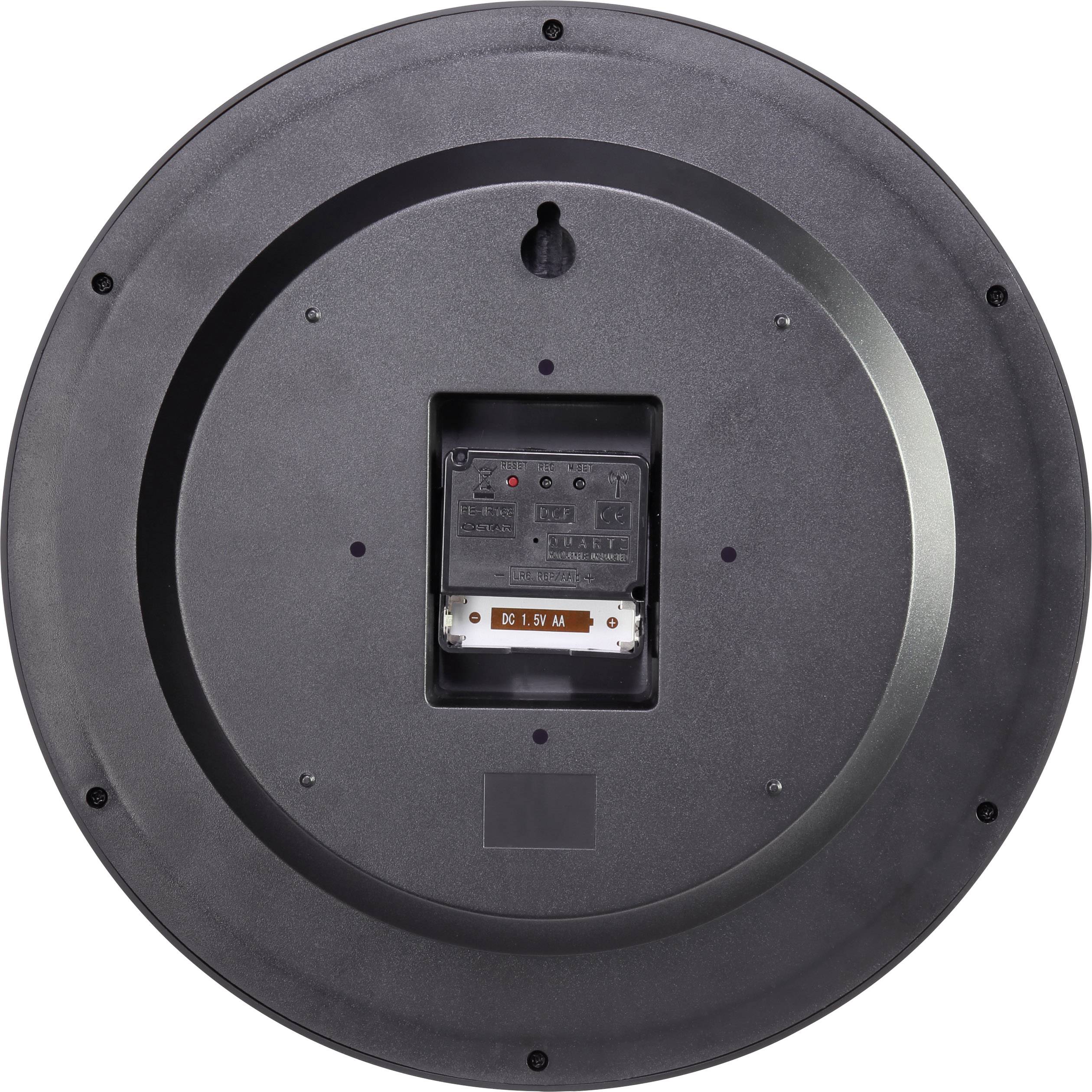 Rückseite einer runden, schwarzen Uhr. Batteriefach und Einstellknopf sichtbar.