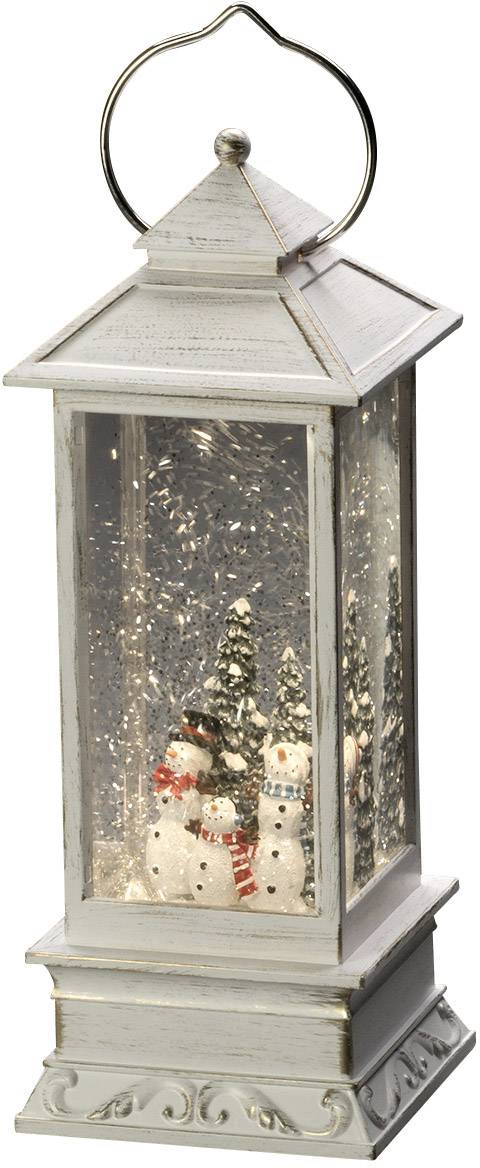 Dekorative Lampe mit Wintermotiv: Zwei Schneemänner im Schneesturm, umgeben von kleinen Tannenbäumen im Inneren einer Laterne.