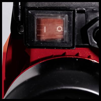 Ein Schalter mit zwei Positionen '0' und '1' auf einem roten Gerät, möglicherweise ein elektronisches oder technisches Gerät.