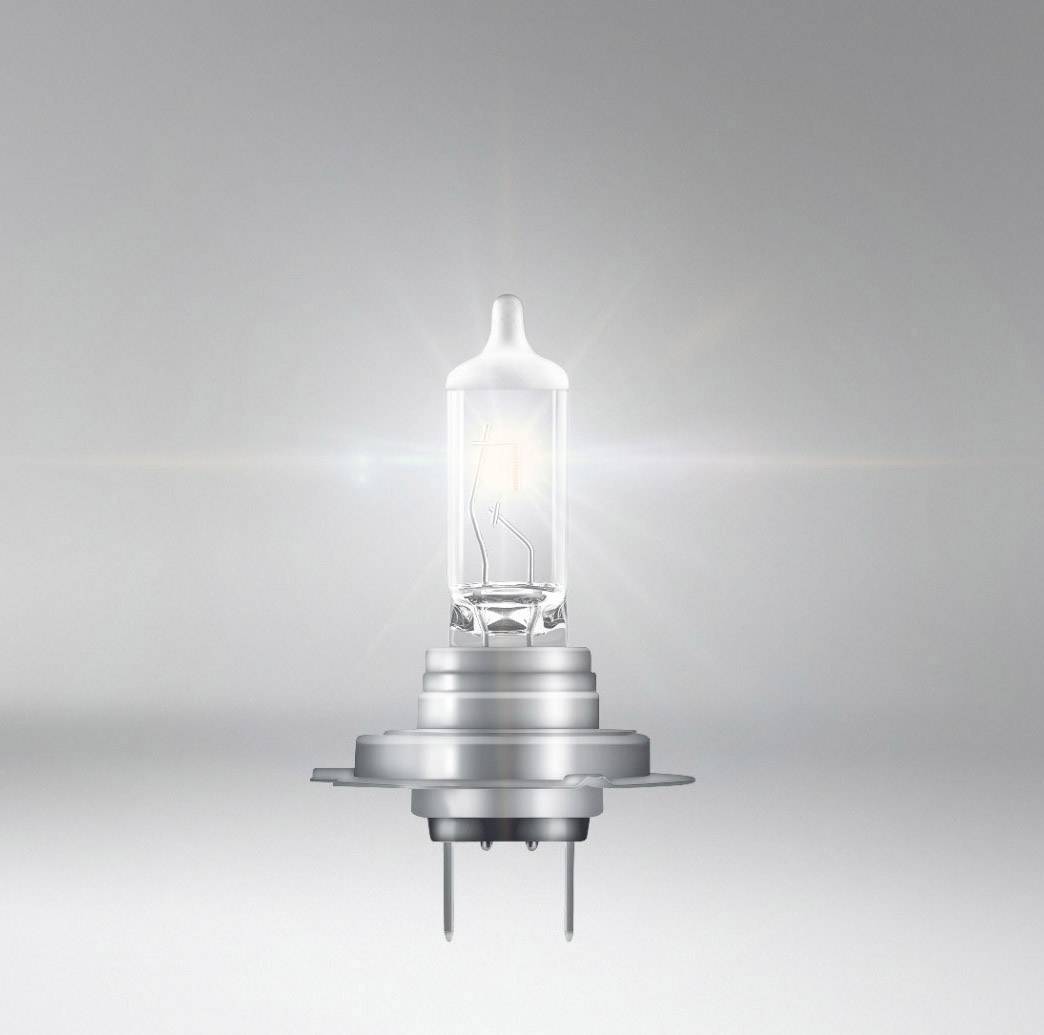 Eine einzelne Halogenlampe vor einem grauen Hintergrund, die hell leuchtet.