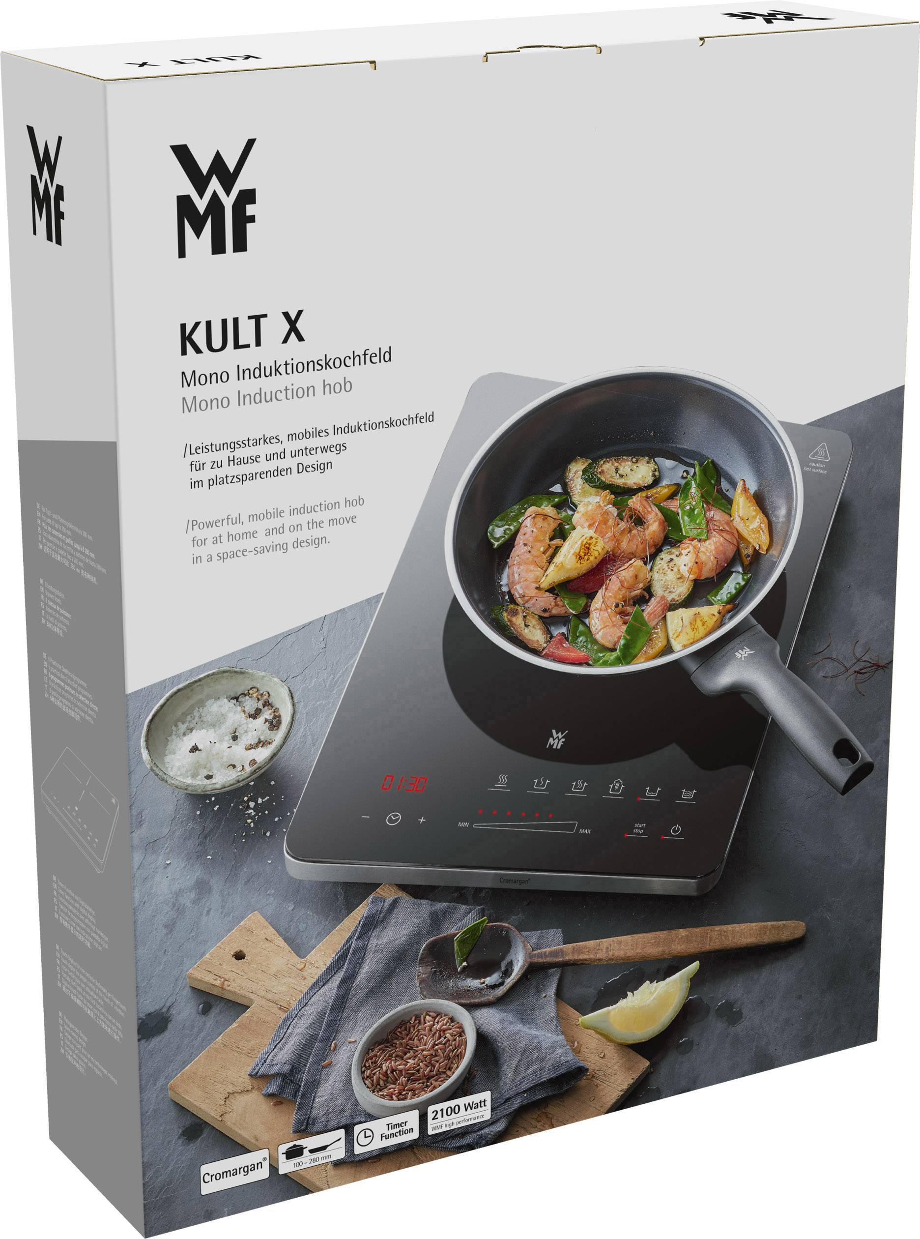 Verpackung eines tragbaren Induktionskochfelds der Marke WMF KULT X, abgebildet mit einer Pfanne voll mit gebratenem Essen.