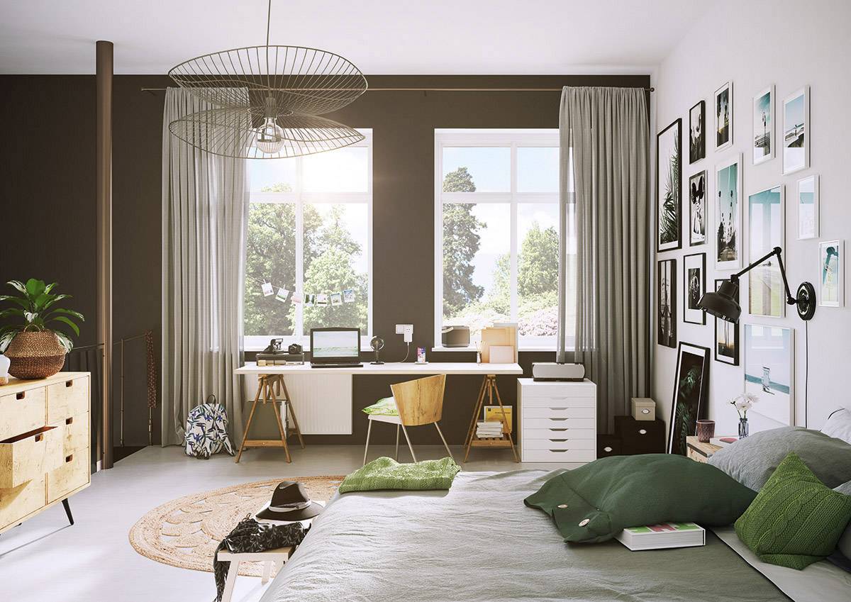 Ein modernes Schlafzimmer mit einem großen Bett, grüner Bettwäsche und Schreibtisch am Fenster. Helle Wände, Pflanzen, gerahmte Bilder.