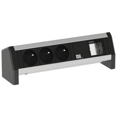 Steckdosenleiste mit drei schwarzen Steckplätzen und einem RJ45-Anschluss auf einem Tisch montiert, Firmenlogo 'Bachmann'.