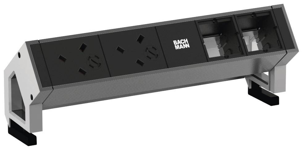 Ein Tischsteckdosenelement mit zwei Steckdosen und zwei Plätzen für Anschlüsse, beschriftet mit 'BACHMANN', auf einem metallischen Gehäuse.