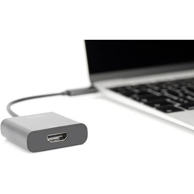 Ein schwarzer HDMI-Adapter ist mit einem Laptop verbunden. Der Laptop ist teilweise sichtbar, mit Fokus auf die Tastatur.