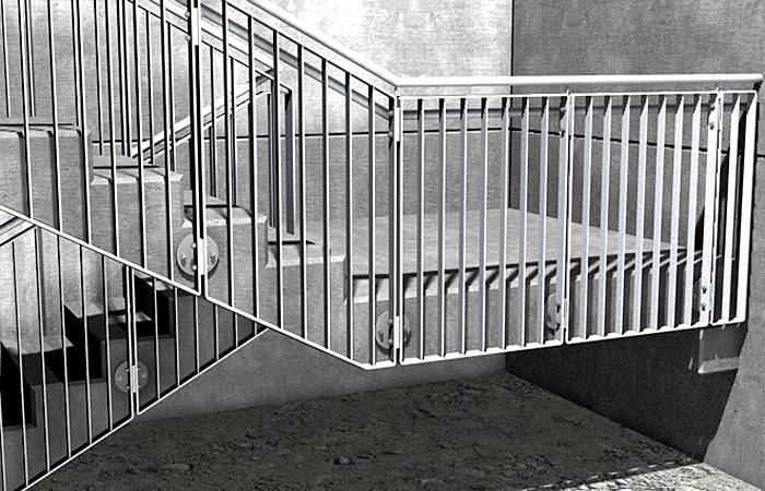 Eine metallene Treppe mit grauen Wänden im Hintergrund.