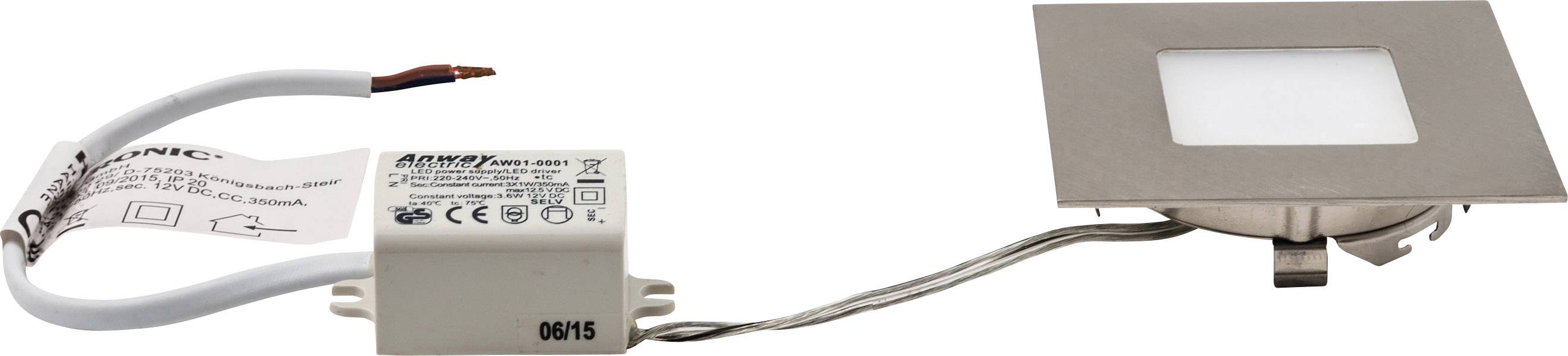 Quadratische LED-Lampe mit Metallrahmen und zwei Drähten, verbunden mit einem kleinen weißen Transformator für Einbauleuchten.