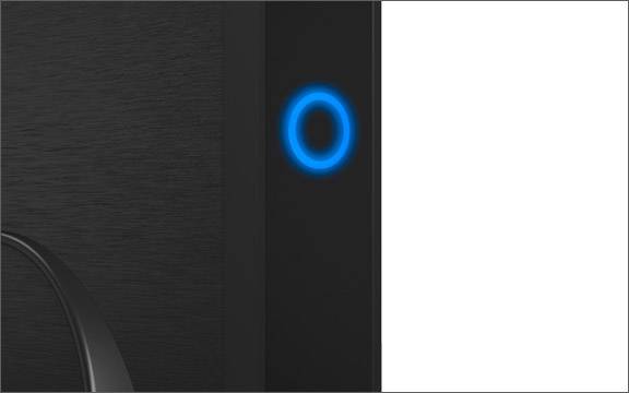 Leuchtender blauer Ring auf schwarzem Hintergrund, vermutlich ein elektronisches Gerät oder Lautsprecher.