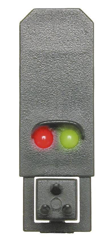 Ein Modell einer zweifarbigen Ampel in Miniaturform mit leuchtendem rotem und grünem Licht, verwendet für Modellbahnen zur Signalisierung.