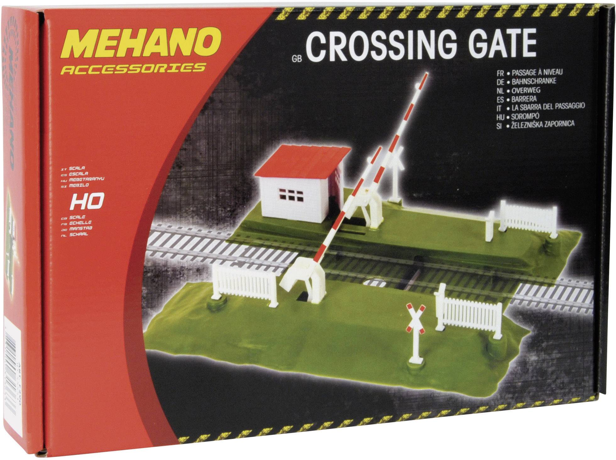 Spielzeugmodell einer Bahnschranke mit kleinem Häuschen und Eisenbahngleisen auf der Verpackung. Marke 'MEHANO'.