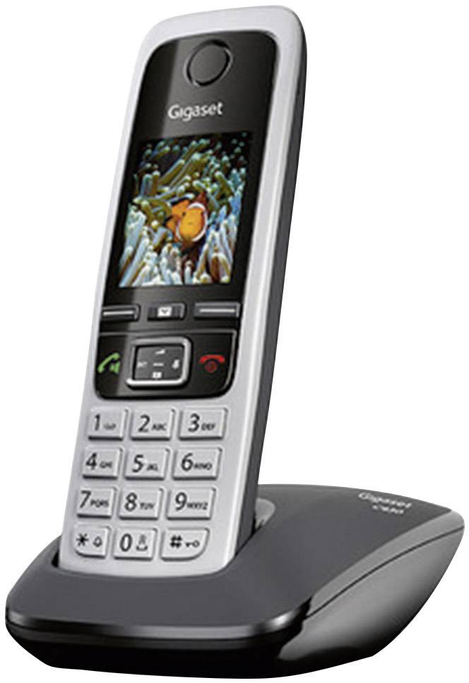 Schnurloses Festnetztelefon auf Ladestation, Display zeigt ein Bild eines Clownfisches an, Tastenfeld und Funktionsknöpfe sichtbar.