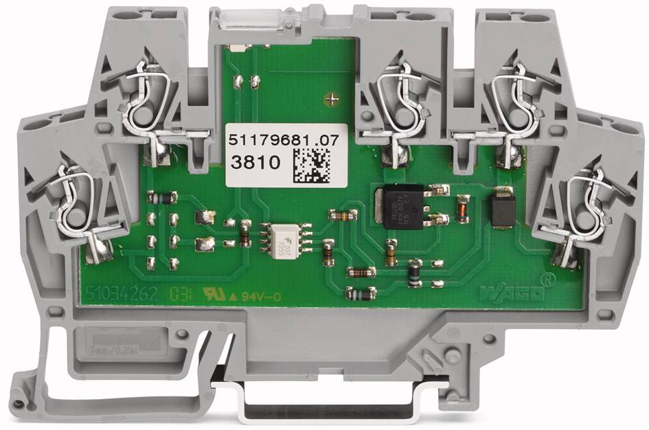 Elektronikbauteil mit grauem Gehäuse und grüner Leiterplatte, darauf verschiedene elektrische Komponenten und Anschlüsse.