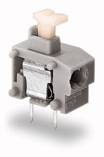 Grauer, rechteckiger Schalter mit zwei Metallstiften und einem hellen Druckknopf oben, verwendet für elektronische Anwendungen.