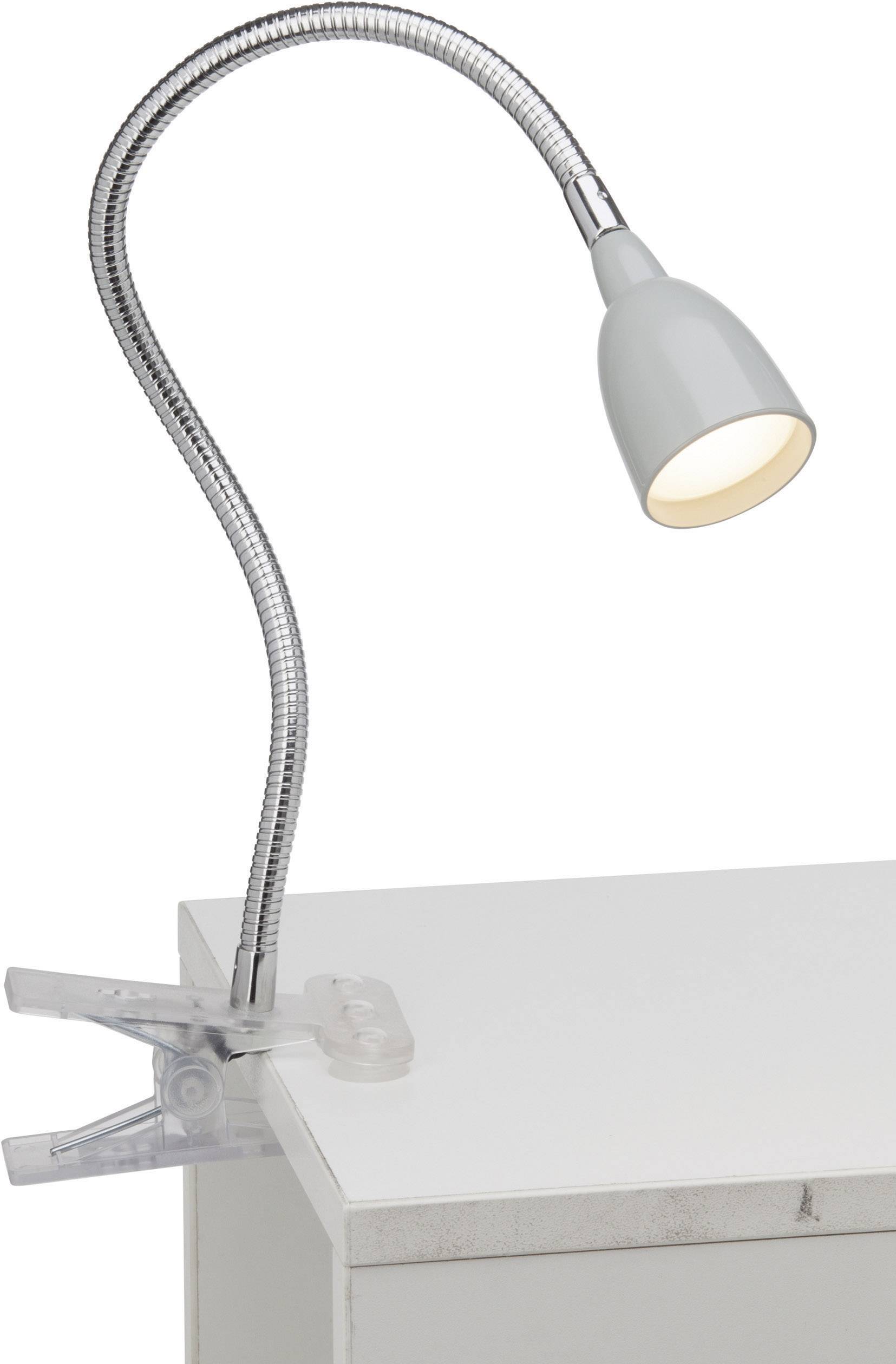 Flexibler Leselampe mit Klemme, befestigt an einer Tischkante. Silberner, biegsamer Arm und cremefarbener Lampenschirm.