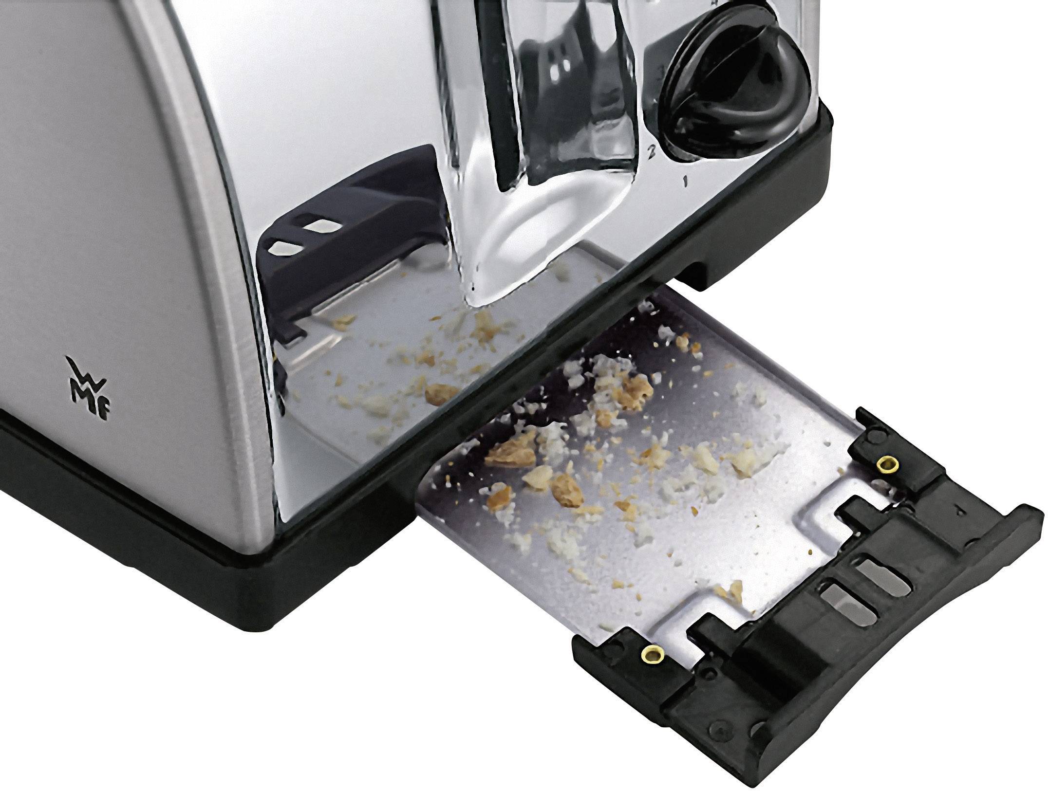 Ein Toaster mit geöffnetem Krümelfach, gefüllt mit Brotkrümeln.