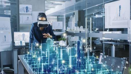Person mit Virtual Reality Headset interagiert mit virtuellem Stadtmodell.