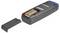 A battery compartment is open on a gray electronic device with a 9V battery inside. The compartment cover is removed, showing the battery.
